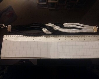 A black and white sailor knot bracelet.