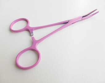Pink curved haemostats