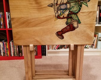 Set of four snack tables with storage rack, decorated with images of your choice. Snack tables are store bought then hand painted.