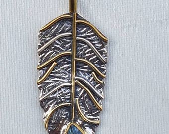 Sterling silver 92.5% feather pendant with sky blue topaz studded