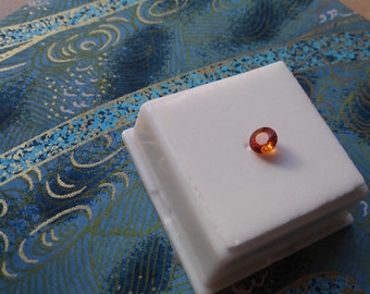 Approximately .80ct 5.5mm Round Spessartite Garnet