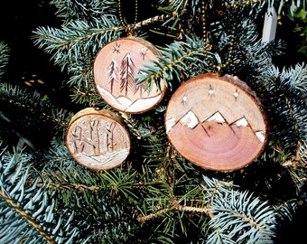 Holiday ornaments, 1 or a set of 3 wood burned designs, live edge birch slices, birch and pine trees, mountains. brass chains, wintry scene