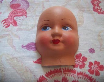 a vintage doll head cardboard painted cloth doll