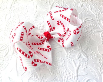 Candy cane bow: Christmas bow on an alligator clip. Red hair bow. Christmas bow headband. Red headband. Candy cane bow headband. 4 inch bow