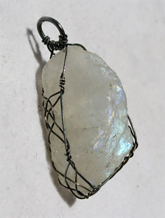Rough rainbow moonstone pendant wrapped Celtic style with oxidized silver