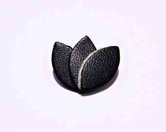 Gold edging and black leather petals brooch