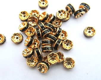6 Vintage Swarovski rondelle beads black crystal rhinestone on gold color base 7mm spacer beads