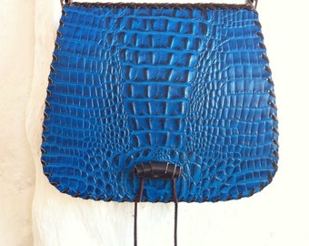 Gaucho bag with blue crocodile print.