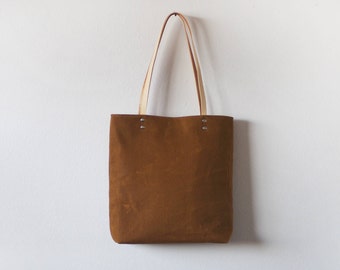 Waxed canvas tote bag with leather handles