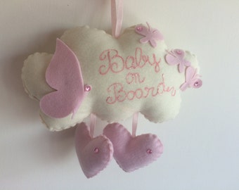 Baby on board a little cloud with butterflies and hearts