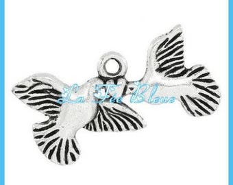 Doves holding a heart shaped pendant charm