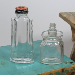 2 Old Embossed Bottles . Cavalier Shoe Dressing Bottle With Embossed Swords and Metal Cap . Double Handled Vinegar Bottle . Collectible