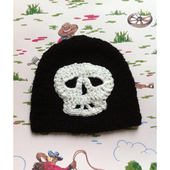 Awesome black crocheted childrens hat with a white skull.