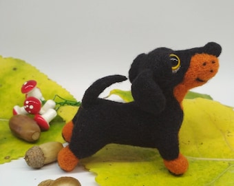 A dog, a soft toy, a toy made of wool, a furred toy, a dachshund, a felt dog, a merry dog, a black dachshund, dog lovers