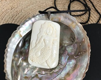 Mermaid with Manatee, Bone Pendant on a Satin cord.