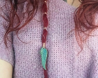 Fake red Rasta with clip. Decorated with copper wire and bronze-wing ornament. 50 long.