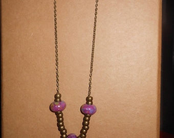 long necklace with bronze and purple ceramic beads