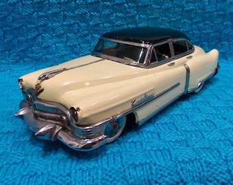 Marusan Toys 1950's Kosuge Cadillac battery electric car. yellow and green friction tin toy car #2203 minicar