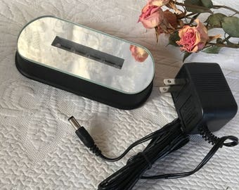Vintage Miniature Light for Displays. Row of Bright Mini Bulbs Under Glass in Center of Mirror Surface in Oval Shape. Display Lights.