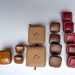Different sets of square buttons in leather, different designs, sizes and colors in variations, red, Brown, old used