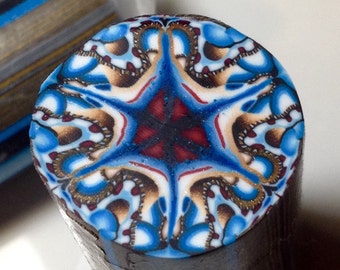 Complex polymer clay cane, blue, red, browns