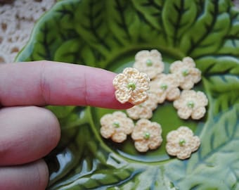 Mini crochet flower appliques with a bead in the middle. Embellishments for your clothes or use for many other things like craft supplies.