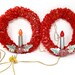 2 vintage red cellophane Christmas wreaths with poinsettia die cut