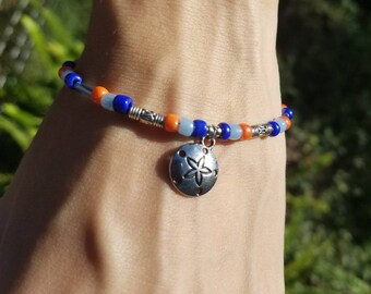 Beaded bracelet with sand dollar charm
