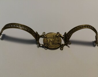 Gold bracelet with Peruvian coin