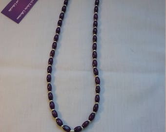 Purple wooden necklace with Celtic knot.