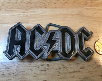 Great American Buckle. AC DC Made in USA 1992. Good condition Serial number 3071.Size ~ 100x40 mm