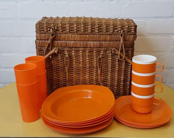 Vintage wicker picnic basket with orange picnic set