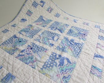 Quilted Square Table Topper in pastel blue Kaffe Fassett prints adds colorful beauty to your home!
