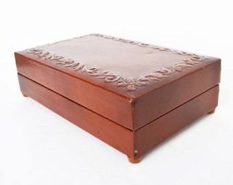 Cigarette music box made of wood lined with embossed leather paper