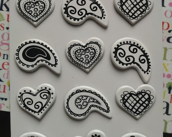 set of 12 Brads in the shape of heart and white and black Teardrop