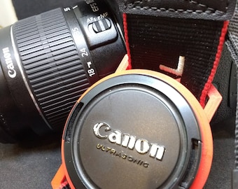 Lens Cap Holder for DSLR camera caps 37-98mm in size and in a range of colours. Fully customisable.