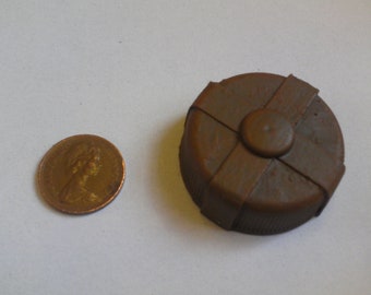 One sixth, or play scale, miniature model post-apocalyptic style landmine in rusty brown.