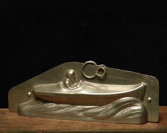 Antique two part chocolate mold of a a man in a speedboat