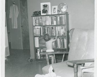 vintage photo 1960 Baby from Back in Diaper Looks at Books Library Soldier Dad in Frame