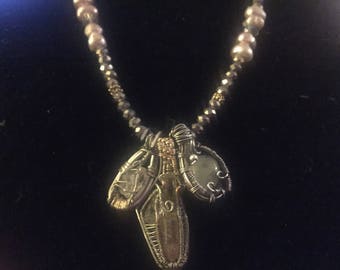 Intricate wire wrapped stone pendant necklace with pearls