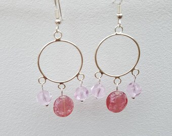 Three pink glass beads on a chandelier drop