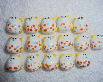 White kittys with colorful spots