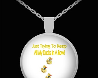 Just trying to keep all my ducks in a row pendant necklace