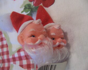 two little rubber santa heads