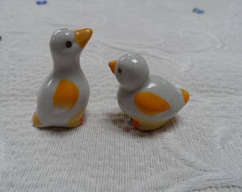 2 ducks yellow dress white a seated and one standing porcelain for collection