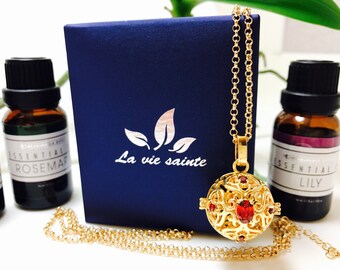 Red cubic zirconia aromatherapy locket with chain.