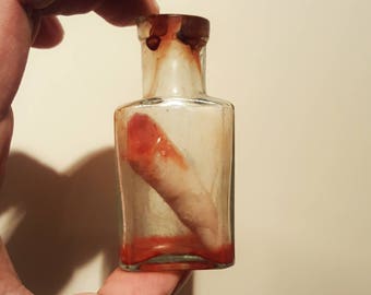 Victorian blood stained glass bottle containing gory severed finger - oddity - halloween - curiosity - horror