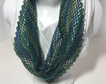 Handwoven beaded necklace in shades of green and blue
