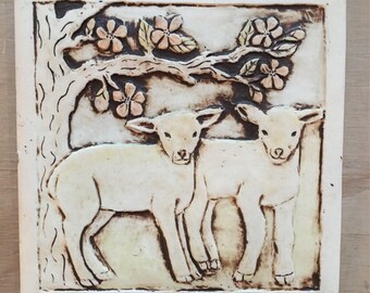 Spring lamb twins under a cherry tree