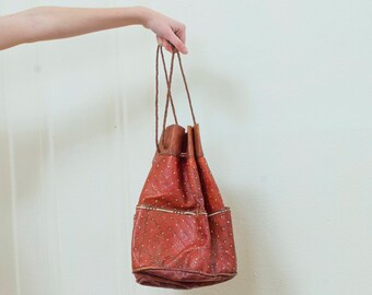 vintage brown tooled leather bag | drawstring embossed leather hobo handbag | braided leather pocket shoulder bag round | 1970s | 70s
